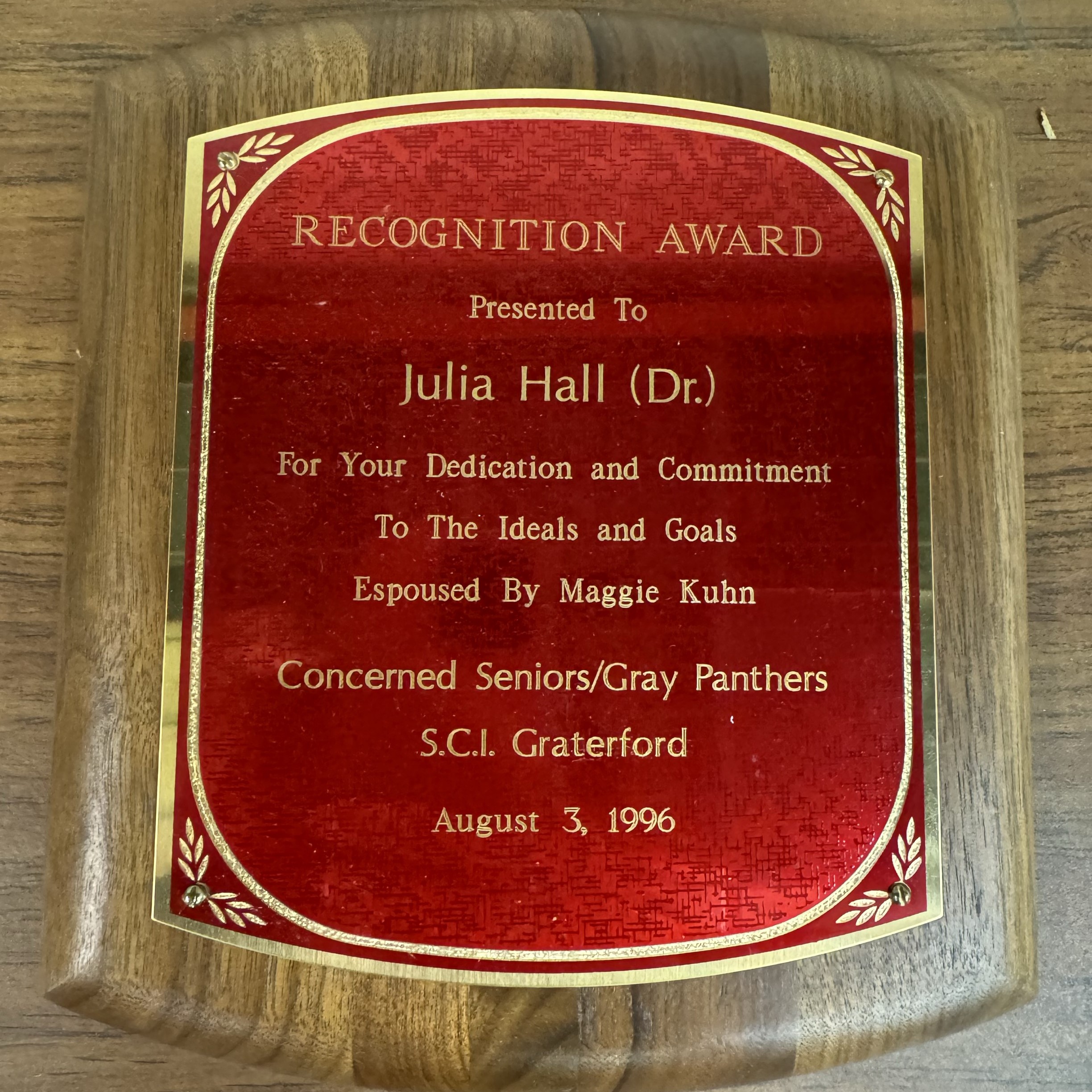 Red and wooden plaque presented to Dr. Julia Hall in 1996 by the Concerned Seniors/Gray Panthers of S.C.I. Graterford.